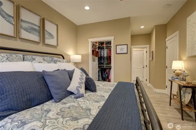 Primary walk in closet with California Closets installed