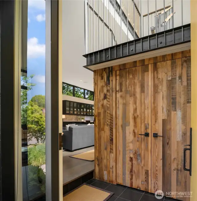 Upon entering the home you see the reclaimed wood accents & the steel staircase which add to the interesting use of textures...and the 12 foot ceilings which give this home the airy volume and light.