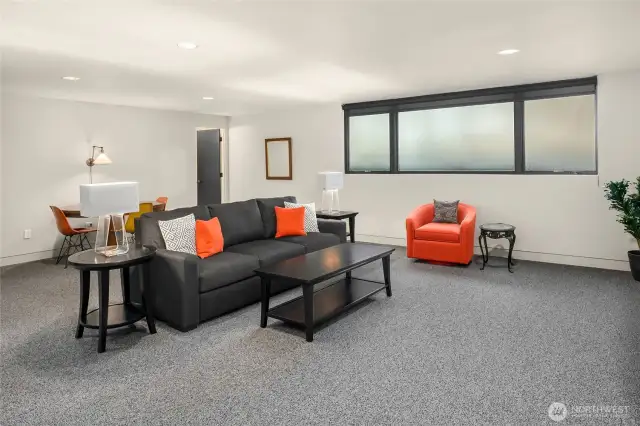 Lower level rec room is large and does not feel like a basement!  There is a full bathroom (at the back of the photo), so you can easily use this room as a bedroom for guests or kids slumber parties!