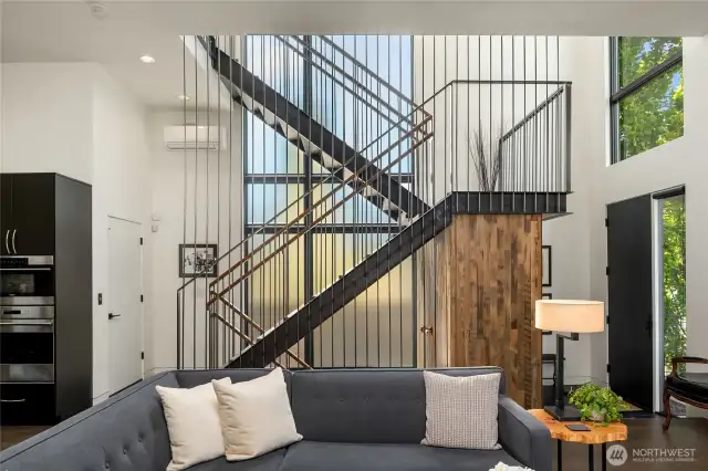 In the living room looking back at the entry and the staircase.  The white door that is shut at the base of the staircase is an elevator which goes to all levels!