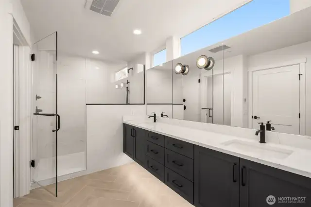 Frameless glass and bold contrast tones create a striking shower space for style and relaxation.