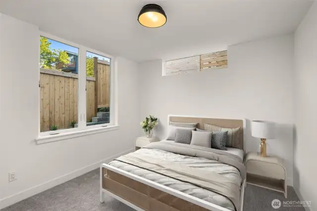 A secondary bedroom features plush carpet and ductless heating/cooling—perfect for peaceful mornings.