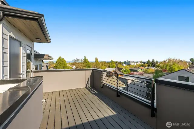 The rooftop deck serves panoramic views of the city and treetops, giving you a front-row seat to sunset skies.