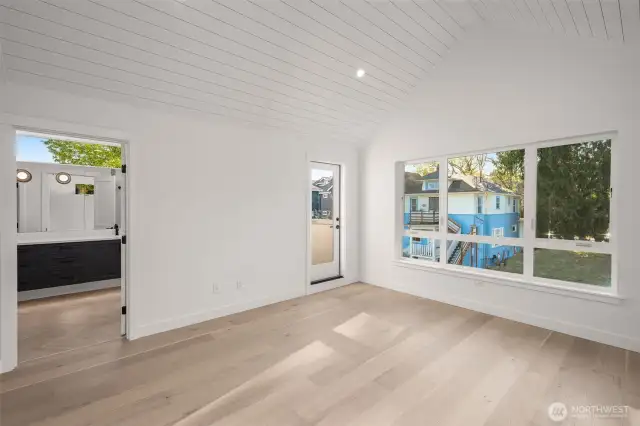 Retreat to the vaulted primary suite, where natural light pours in through oversized windows—your calm escape above it all.