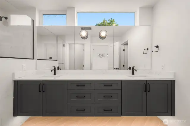 A peek into the luxe en suite bath—dual sinks, matte black hardware, and elegant finishes for a spa-like experience.