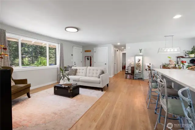Looking towards hall to bedrooms.  Huge island on the right and living space on left.  Great home for entertaining.
