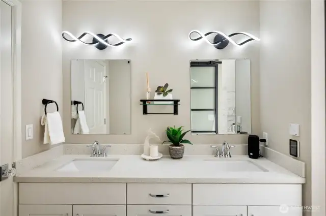 Dual sink vanity with designer light fixtures in the primary bath.