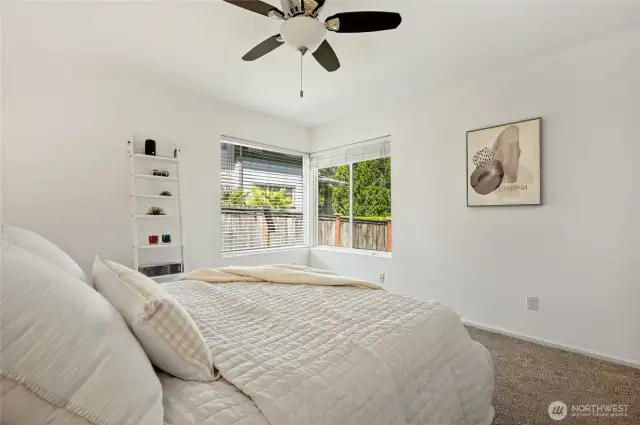 Sunshine filled, spacious bedroom with overhead fan, and lake views!