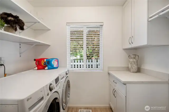 Laundry room with built-ins and shelving for added storage.