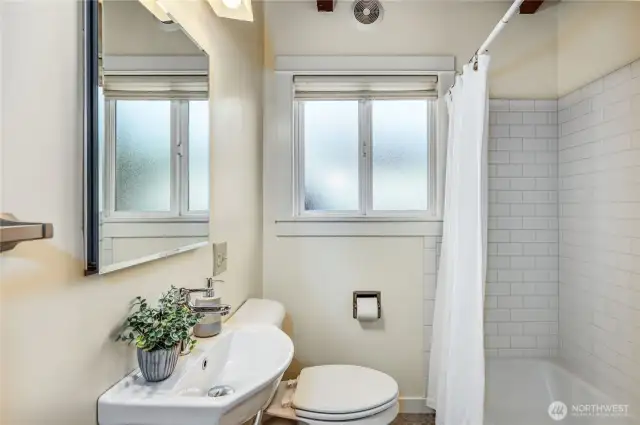 Full bath with heated tile floor and new cast iron bathtub.