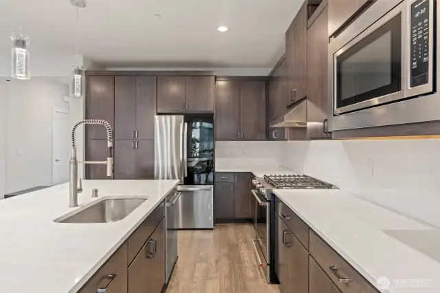 Discover culinary excellence in this luxurious kitchen, outfitted with a top-of-the-line LG refrigerator and premium KitchenAid appliances.