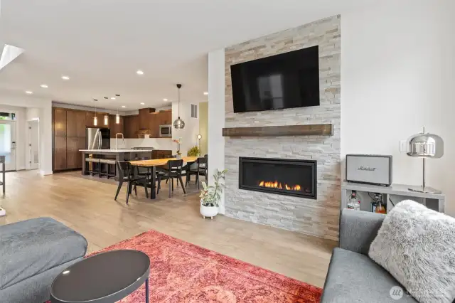 Gather around the large gas fireplace in this inviting living room, perfect for cozy evenings.
