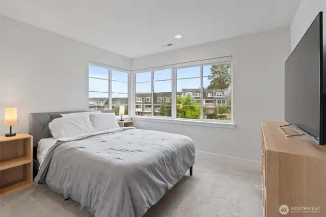 Relax and recharge in an expansive bedroom featuring breathtaking views.
