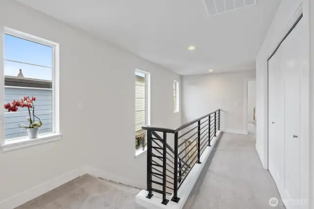 Ascend to the second floor on sun-drenched stairs, bathed in abundant natural light.