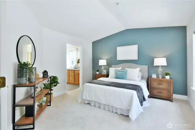 Primary bedroom with additional vaulted ceilings