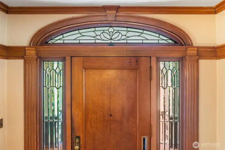 Original details, like this decorative glass surrounding the front door, showcase a time when quality was forever.