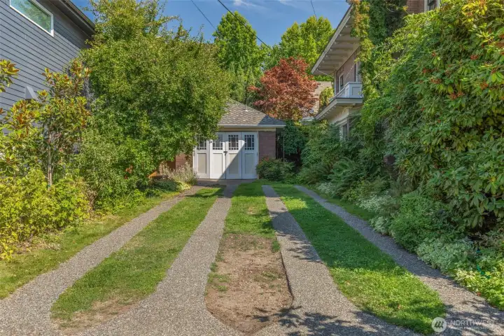 Double driveway has detached garage and two EV chargers; one on each side.