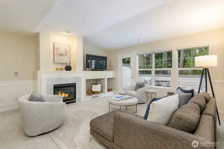 Living room features vaulted ceilings, gas-burning fireplace and access to the deck.