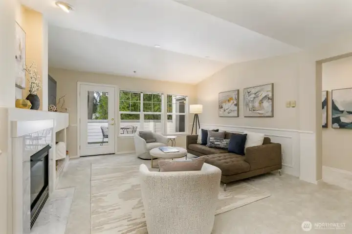Living room features vaulted ceilings, gas-burning fireplace and access to the deck.