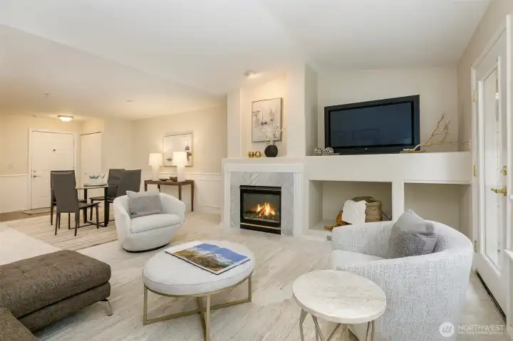 Living room features vaulted ceilings, gas-burning fireplace and access to the deck.