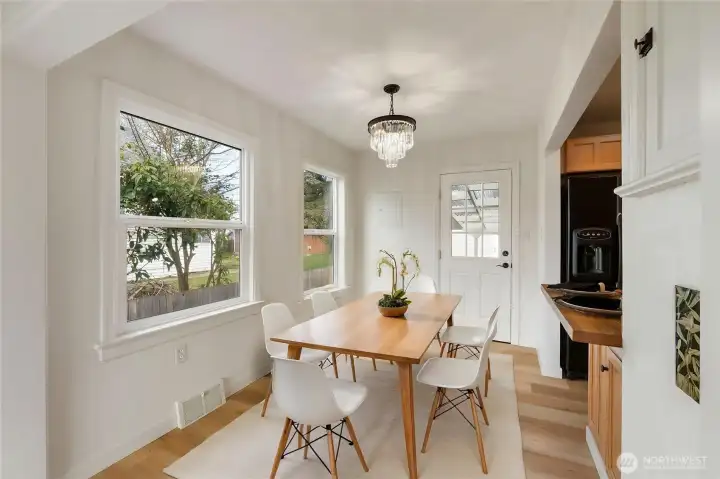Virtually staged dining area with new chandelier