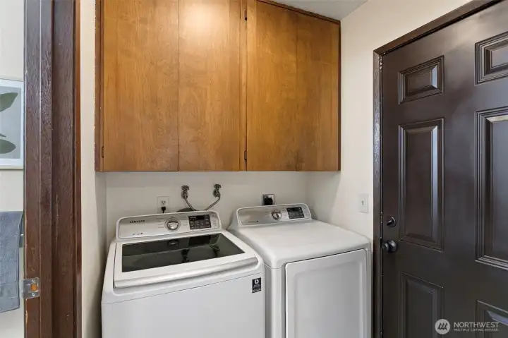 Tucked away by 9549 side door is a designated laundry space and utility cabinets.