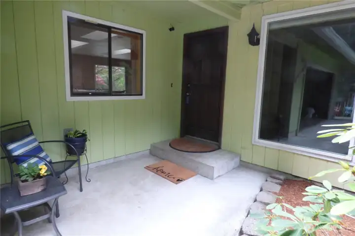 Welcome home! Covered front porch great place to wait for your guests to arrive.