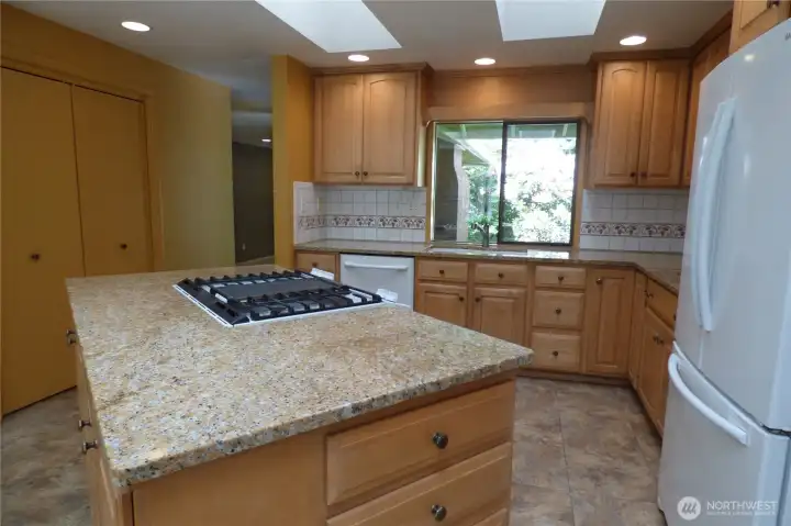 Another view of kitchen overlooking the front porch and into the living room. Notice the skylights too!