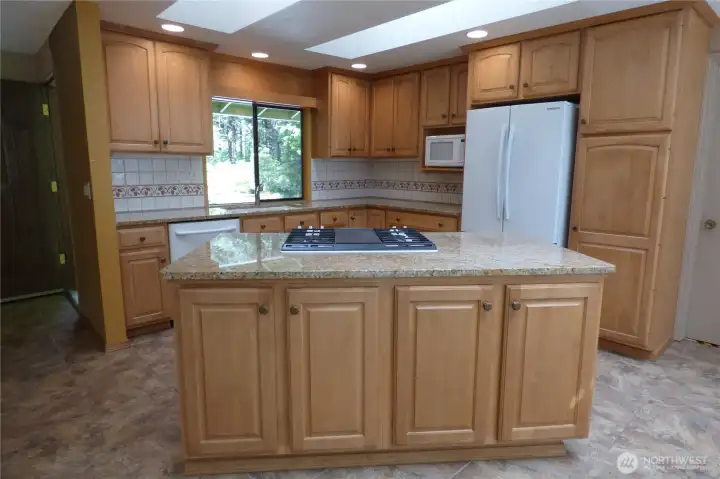 Lots of cabinets and ceramic tiled floors.