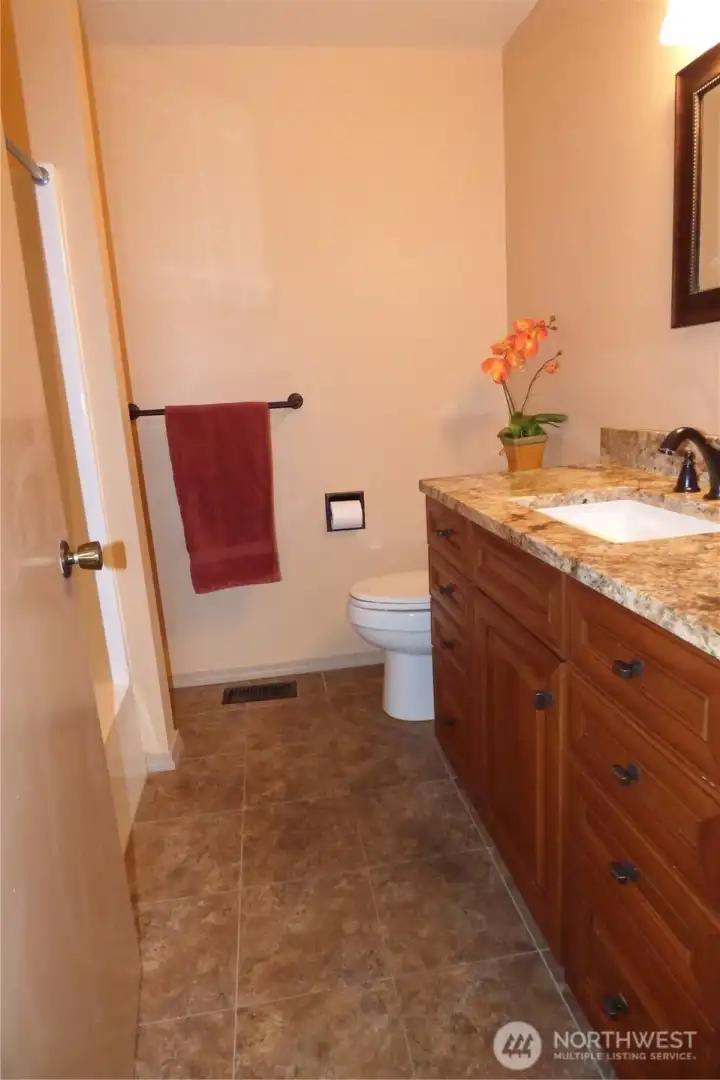 Full guest bathroom with granite counters.
