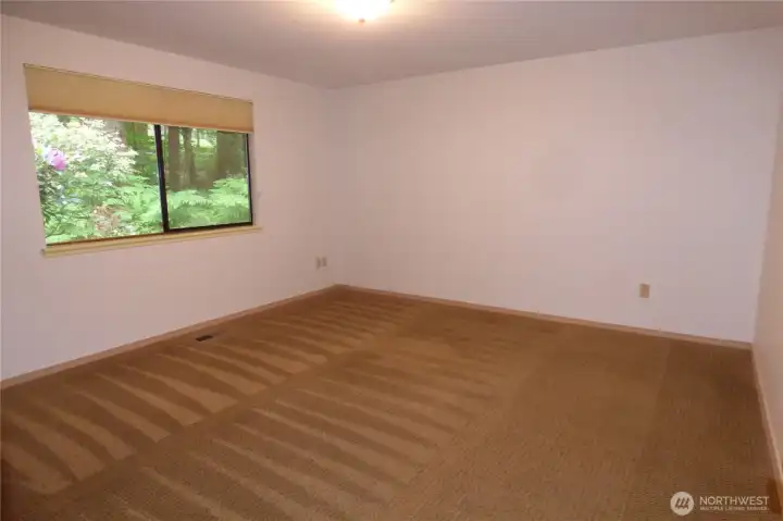 Good sized primary bedroom with freshly cleaned carpet.