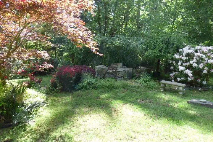 Once upon a time, in the backyard there was a waterfall and fountain here - just needs a little tlc.