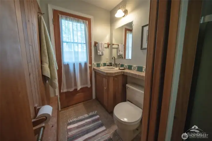 Half bath on lower floor with access outr to deck and outdoor shower. Half bath on lower floor with access outr to deck and outdoor shower.