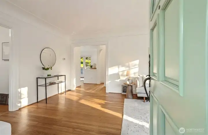 Entering through the front door into the living room. Sunshine and gleaming hardwood floors! Entering through the front door into the living room. Sunshine and gleaming hardwood floors!