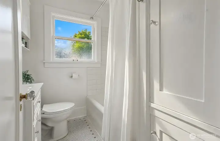 Main floor full bathroom. Original tile floor and bathtub. Main floor full bathroom. Original tile floor and bathtub.