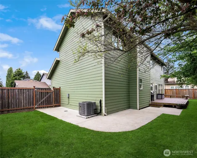 Back yard, heat pump, concrete pathway to deck