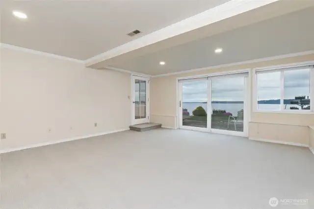 Lower floor living room has new carpet, slider access to enjoy the grounds and the salty air.