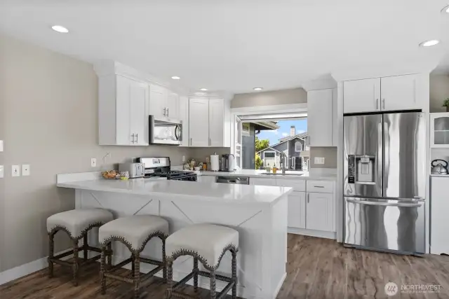 Kitchen with quartz countertops with door to the wraparound deck