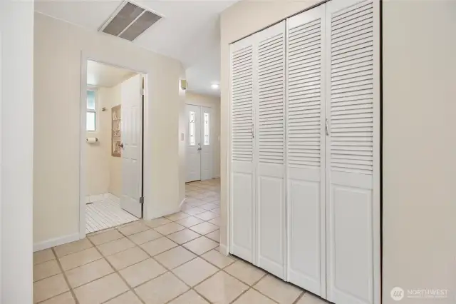 A view of the entry hall, powder room and laundry area.
