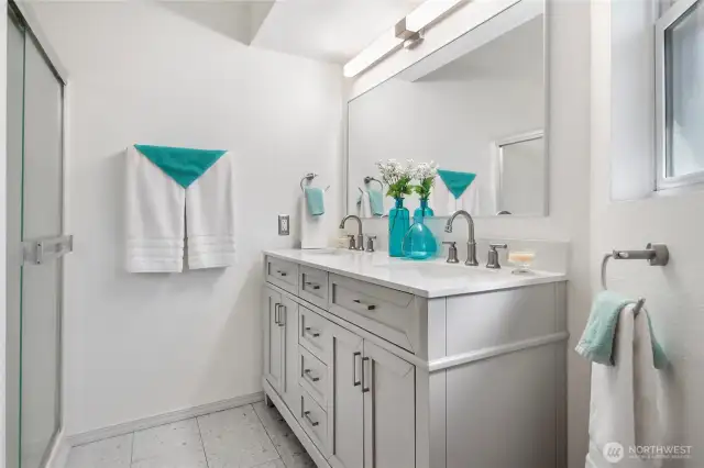 The recently updated bathroom with new flooring, vanity and counter.