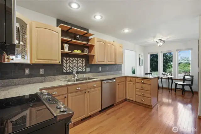 Beautiful wood cabinetry with hard surface countertops and backsplash. All appliances stay with home.