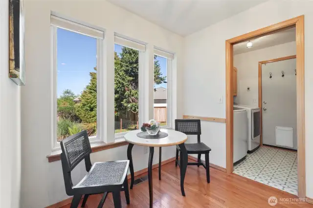 Another view of breakfast area leading to laundry room and garage entry. Washer and dryer stay as well.