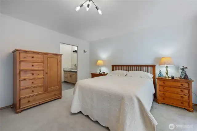 Another view of primary bedroom leading into ensuite. All bedrooms have new carpet.