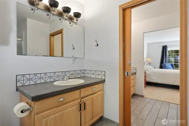 Dual vanities split by a pocket door.