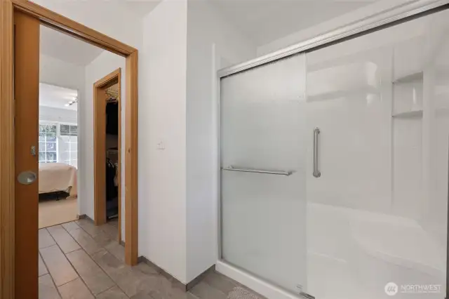 Nice walk-in shower with bench for comfort.