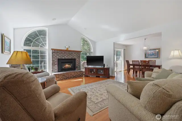 Main living with propane fireplace and plenty of windows.