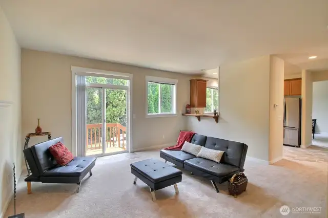 Slider off the family room leads to the deck, patio and fully fenced back yard. You can also see the passthrough to the kitchen and breakfast bar. Off to the far right is the entry to the formal dining room.