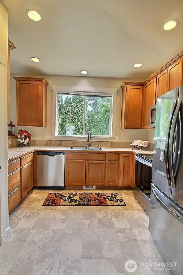 New flooring in the kitchen plus a new sink! Huge window looks out to the backyard.