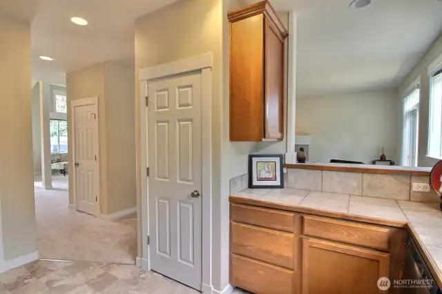 Great use of space with tons of cabinets and pantry right in the kitchen! Stylish tile counters and backsplash add to the refined extras in this home. Nice view of the floorplan as you can see back into the living room.