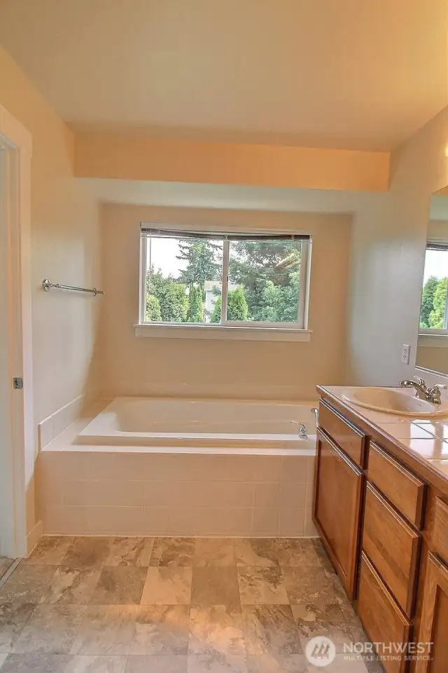 Large dual sink vanity with tiled countertops.